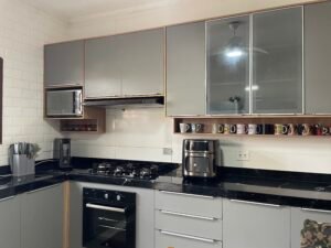 Cozinha na cor cinza sagrado e tamponamento com o teca soberano